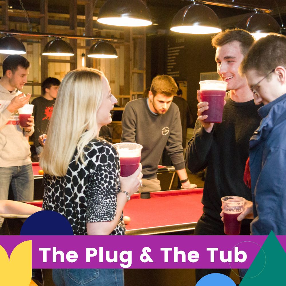 students enjoying a drink in SU bath bar next to pool table