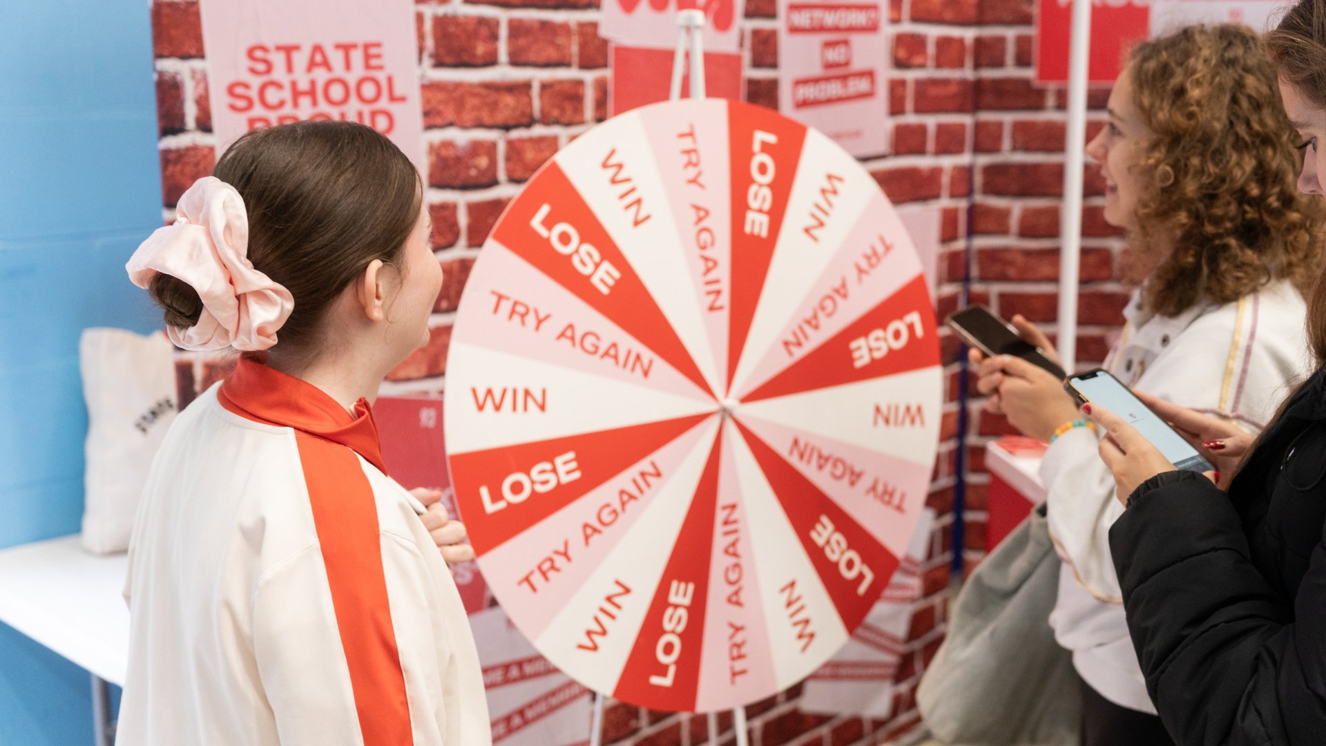 students spinning a business wheel to win prizes