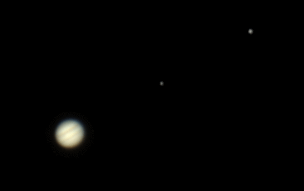 Colour photo of Jupiter. Moons Europa and Ganymede can also been seen.